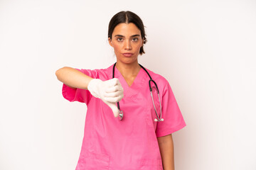 Wall Mural - pretty hispanic woman feeling cross,showing thumbs down. veterinarian concept