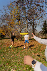 Wall Mural - Three friends playing frisbee