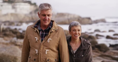 Poster - Happy, in love and affectionate senior couple taking a romantic walk on the beach in the morning. Smiling, retired and loving mature man and woman spending time together and bonding by the sea