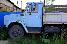 Old Abandoned Blue Truck With Rusted Parts And Damaged Paint