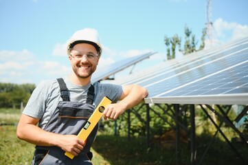 Wall Mural - Worker installing solar panels outdoors