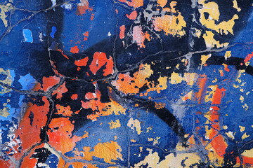 Colorful wall background with damaged paints of blue