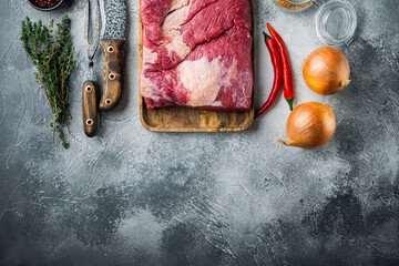 Wall Mural - Point brisket, raw beef brisket meat,with ingredients for smoking  making  barbecue, pastrami, cure, on gray stone background, top view flat lay,  with copy space for text