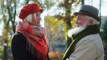 Amazing Beautiful Old Woman And Old Man Charismatic And Casual Have A Good Time Together In The Middle Of The Park Have A Conversation In Front Of The Camera They Hugging Each Other In A Cold Autumn