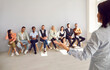 © Studio Romantic - Back view of female speaker talk lead seminar with diverse employees at company training. Woman leader or presenter make speech head briefing with colleagues in office. Leadership concept.
