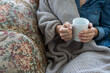 © Angelov - warm cup of hot coffee warming in the hands of a girl.