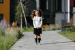 © Ruslan Ivantsov - a little girl goes to school through the park along the path. distance education concept. schoolgirl returning home from school