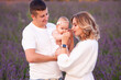 © alipko - Beautiful young family on purple flower lavender field. Family vacation