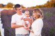 © alipko - Beautiful young family on purple flower lavender field. Family vacation