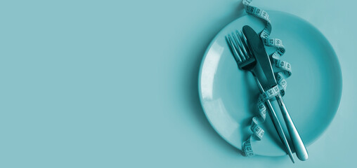 Wall Mural - Fork, knife, plate measuring tape on a colored background