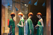 Female Mannequins Wearing Stylish Green Clothes Collection. Dummies In The Store Window. Fashion & Style Storefront