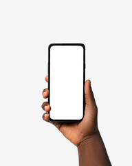 black hand holding phone facing camera isolated on white background. blank screen, phone screen mock