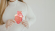 © SewcreamStudio - woman holding heart anatomy, heart attack, heart disease, health concept