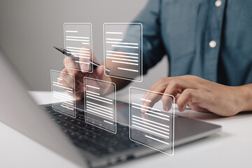 Leinwandbilder - A businessman using a laptop computer with electronic document icons, E-document management, an online documentation database, and the concept of a paperless workplace.