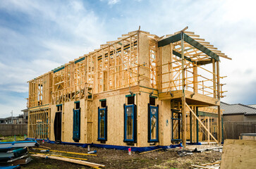 Wall Mural - The structure of a two-story residential suburban house under construction. Concept of real estate development, self-build a new home, Australian housing market, and homeownership. Melbourne VIC