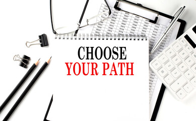 Wall Mural - CHOOSE YOUR PATH word on notepad with clipboard , chart and calculator, business concept