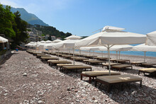 Umbrellas On Sveti Stefan Beach, One Of The Most Beautiful Beaches In Montenegro. Europe
