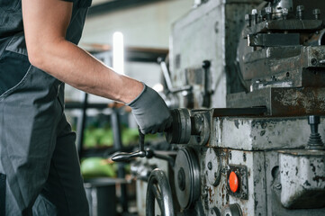 Close up view. Man in uniform is in workstation developing details of agriculture technique