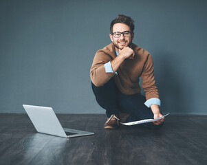 Aufkleber - Happy business man working on laptop, doing tax paperwork and going through finance document while sitting on floor in an office at work. Portrait of entrepreneur planning and completing a project