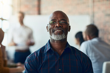 Poster - Mature business man sitting in a meeting, conference or seminar in a boardroom with colleagues at work. Closeup portrait of face of a senior, happy and corporate professional in a training workshop