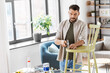© Syda Productions - furniture restoration, diy and home improvement concept - man with hammer and nail repairing old wooden chair