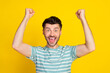 © deagreez - Closeup photo of young funny celebrating guy fan victory hooray win football club isolated on yellow color background