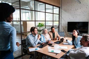 start up business team in the office. Multiethnic group working together on a new project in the conference room