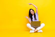 Photo of cheerful positive satisfied lady sit two arm index empty space sale discount modern devices isolated on yellow color background