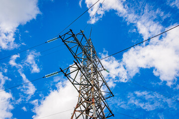 Wall Mural - Old rusty High voltage power switchgear station, high voltage power line, line and insulated at sunny blue cloudy sky.