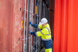 © visoot - Workers working at containers inside the warehouse,Logistic and business export,Industrial Container yard for Logistics oversea import export shipping business.