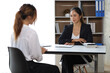© Wasan - Female manager in office discussing and interviewing job applicant for new employees.