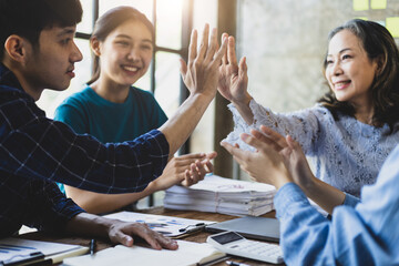 Group colleague in the high five office encourage working together to motivation them for successful work. The concept of unity and teamwork.