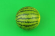Leinwandbild Motiv Watermelon on green background close up.