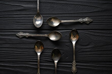 Directly Above A Shot Of Old Spoons On A Black Table