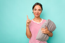 Young Hispanic Woman Holding A Cushion Isolated On White Background Showing Number One With Finger.