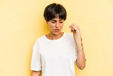 Fototapeta Na ścianę - Young caucasian woman hand sling isolated on yellow background
