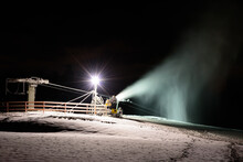 Artificial Snow Blowing Works On The Ski Hill At Night In Winter