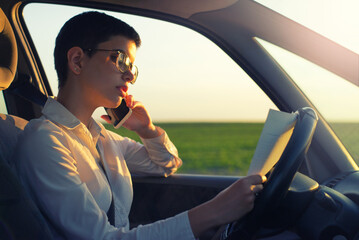 Woman talking on the smart phone during business travel on a sunny summer day