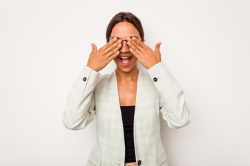 Poster - Young hispanic woman isolated on white background covers eyes with hands, smiles broadly waiting for a surprise.