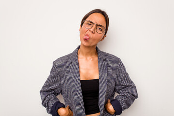 Wall Mural - Young hispanic woman isolated on white background funny and friendly sticking out tongue.