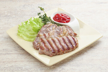 Grilled pork neck steak with ketchup