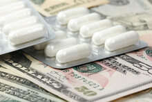 Unopened Containers With Medicines On Dollar Bills. The Concept Of Expensive Medicine Or Illegal Sale