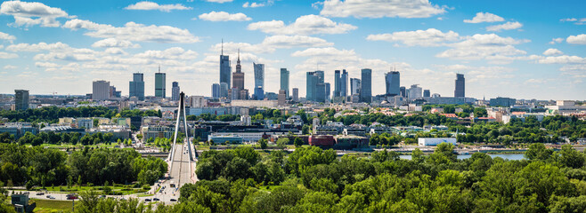 Swietokrzyski bridge and skyscrapers in city center, Warsaw aerial panoramic landscape under blue sky