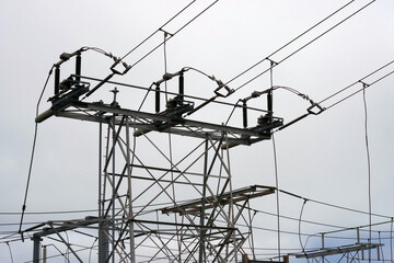 Electricity station and power lines under gray cloudy sky