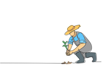 Wall Mural - Single continuous line drawing young male farmer planting plant shoots in the ground. Start the planting period. Minimalism metaphor concept. Dynamic one line draw graphic design vector illustration.