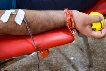 Blood Donor At Blood Donation Camp Held With A Bouncy Ball Holding In Hand At Balaji Temple, Vivek Vihar, Delhi, India, Image For World Blood Donor Day On June 14 Every Year, Blood Donation Camp