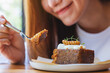 © Farknot Architect - Closeup image of a beautiful woman eating and showing a piece of carrot cake with fork