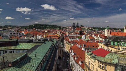 Wall Mural - Top view from the height Powder Tower in Prague timelapse to Old Town. Historical and cultural monument. Houses with green and red roofs. Prague, Czech Republic.