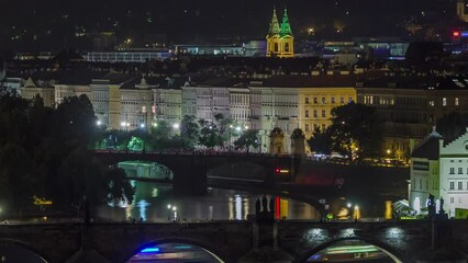 Wall Mural - Scenic view of bridges on the Vltava river night timelapse and of the historical center of Prague: buildings and landmarks of old town with Charles bridge and multi-coloured walls.