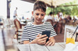 © Mediteraneo - Boy addicted online games outdoors. Boy use phone and plays games.